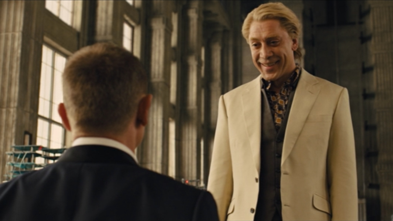 Javier Bardem stands smiling in front of a captive Daniel Craig in Skyfall.
