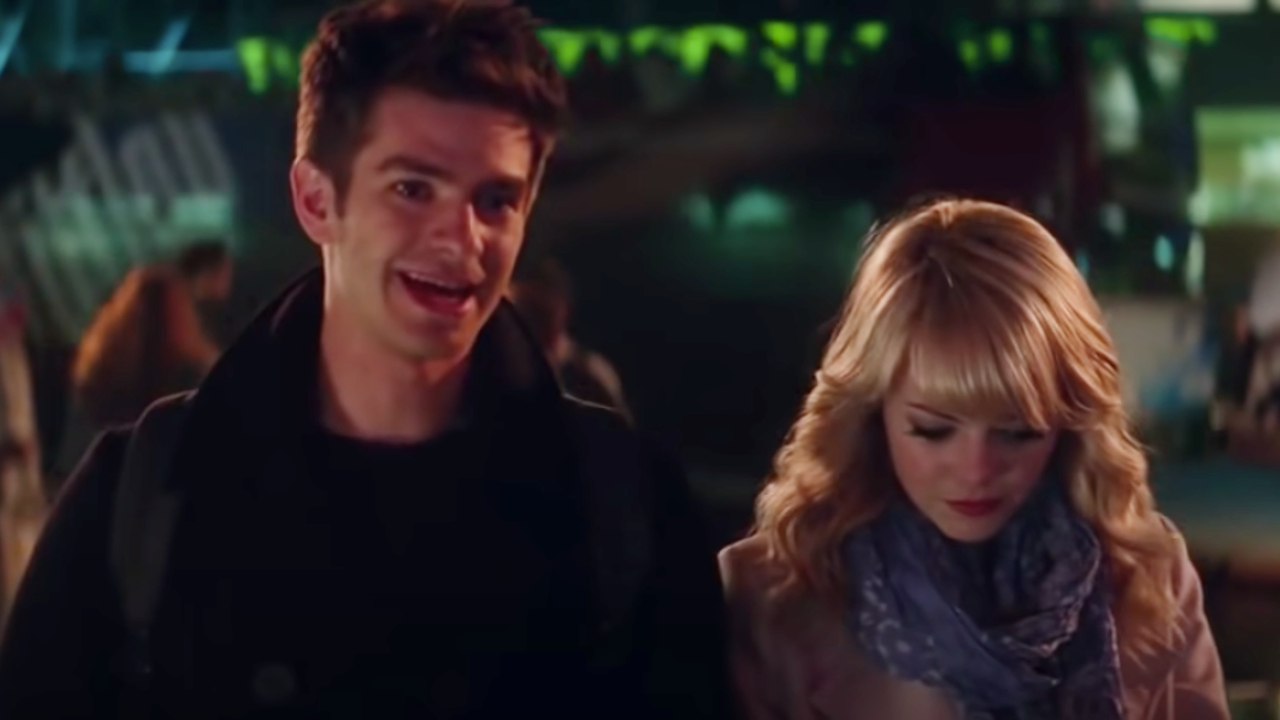 Andrew Garfield and Emma Stone walking in the park at night in The Amazing Spider-Man 2.