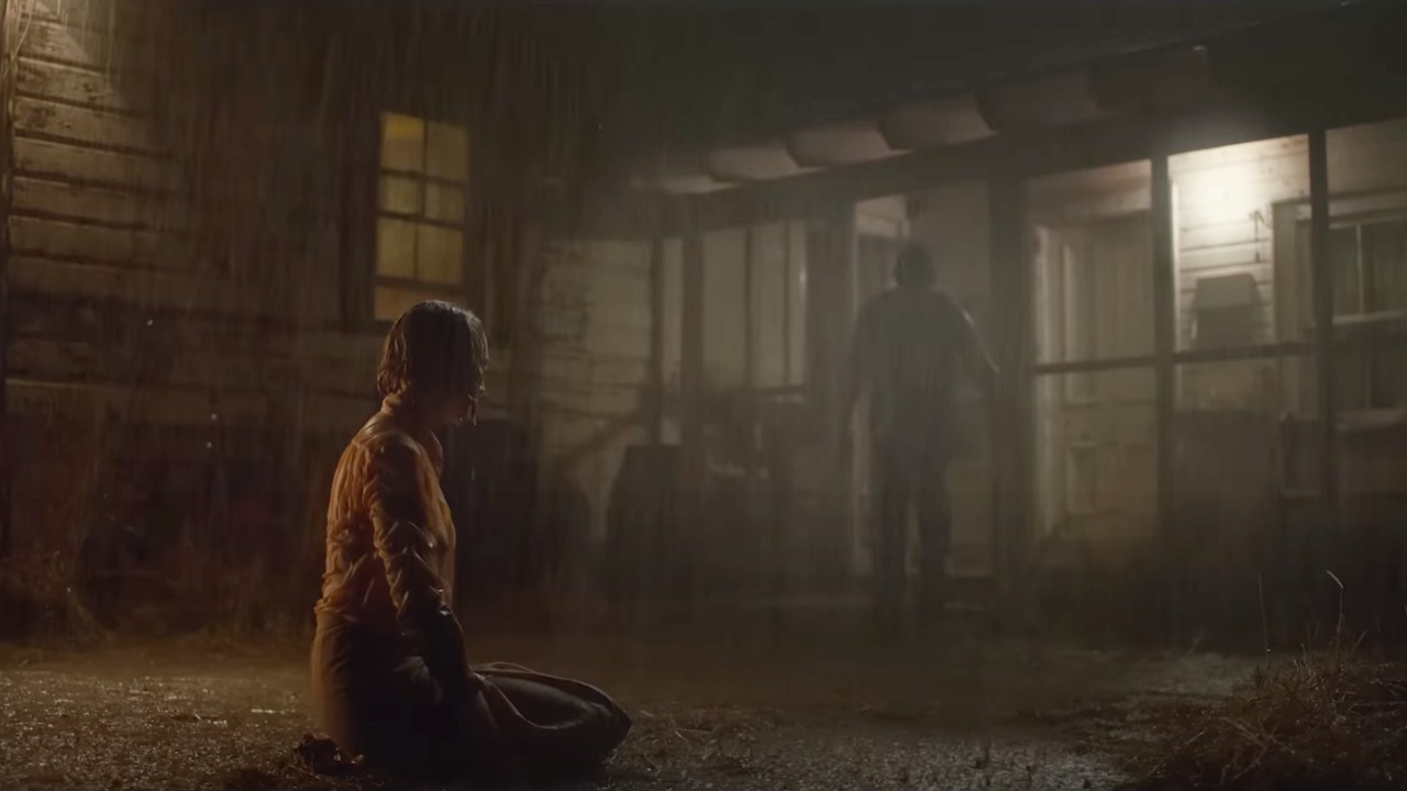 Ein Screenshot aus Foes Trailer, der zeigt, wie es regnet und Jr. hineinrennt, während Hen draußen sitzt.
