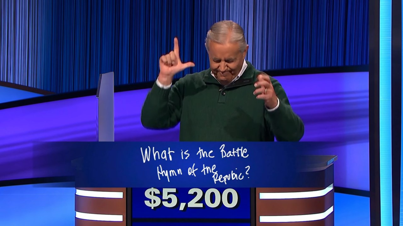 Участник Брайан делает L руками, проигрывая Jeopardy