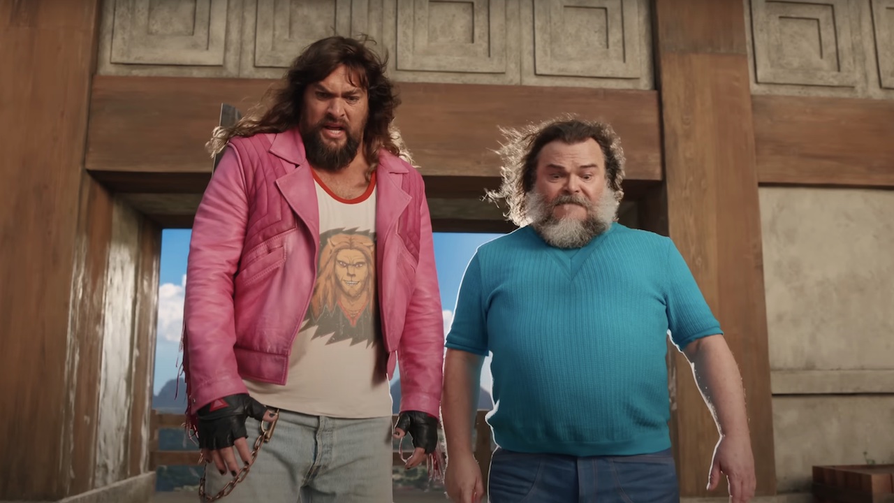 Jason Momoa and Jack Black looking down cliff ledge in A Minecraft Movie